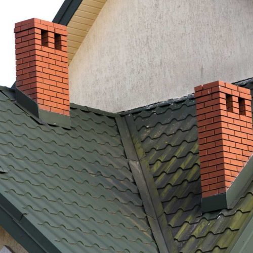 Close-up detail of new modern house top with shingled green roof