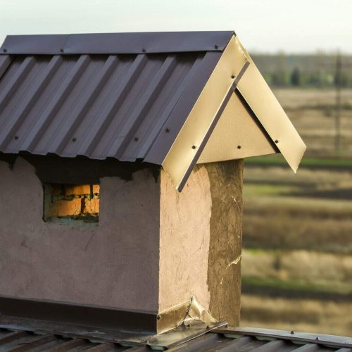 Close-up of a new built chimney on a house roof under construction. Unfinished building, repair and