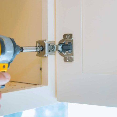 Place carpentry workshop mounting hinges for chipboard furniture assembling kitchen furniture.
